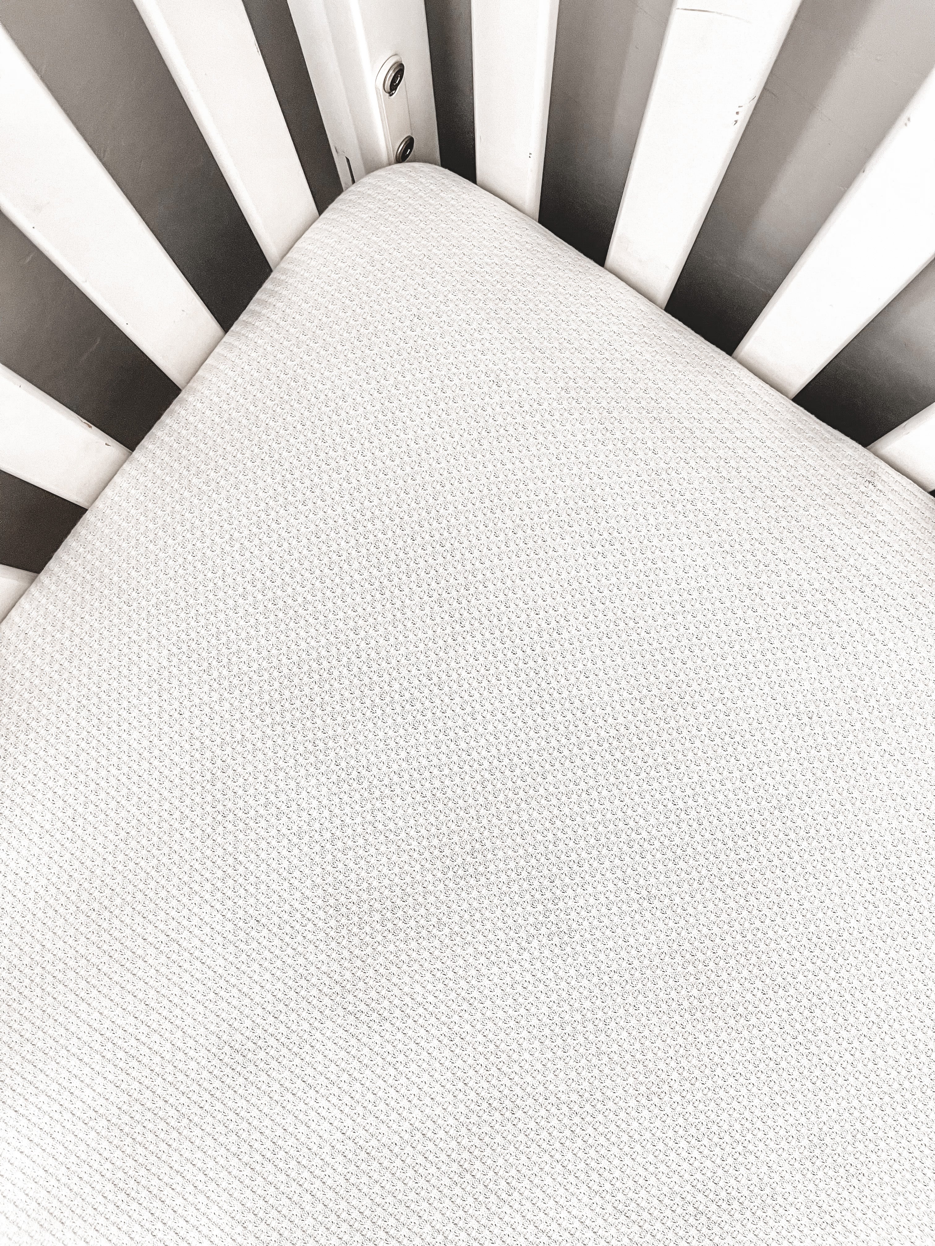 Black and white striped crib sheet top